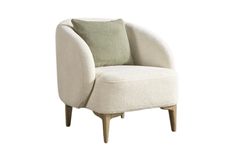 Torino Berjer: cozy cream upholstered armchair with a green accent pillow and wooden legs.